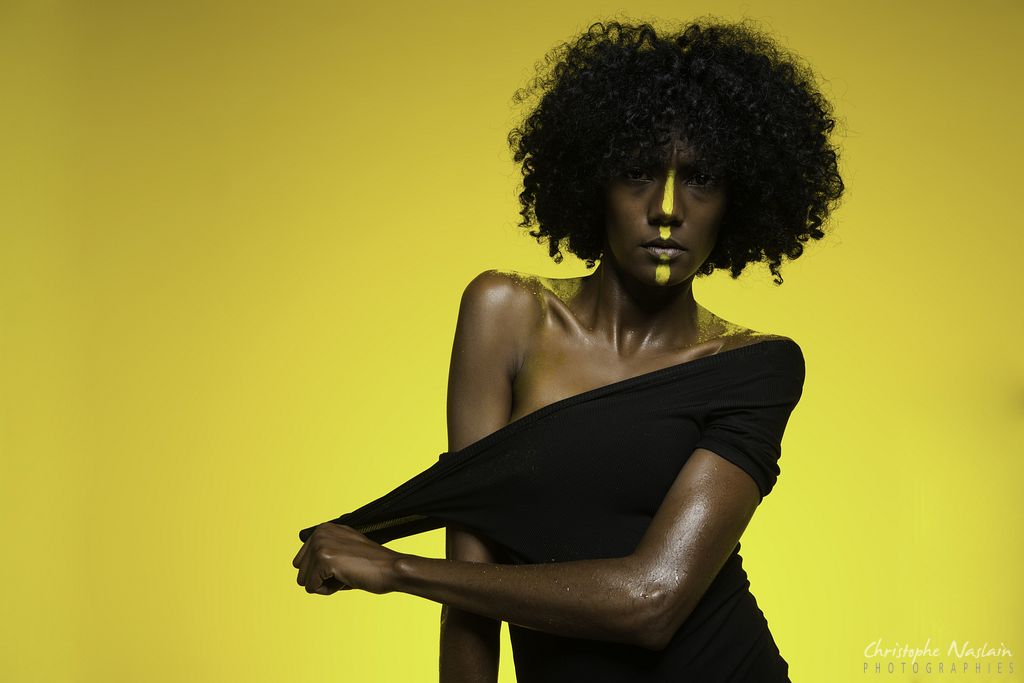 The black bodysuit and the yellow wall